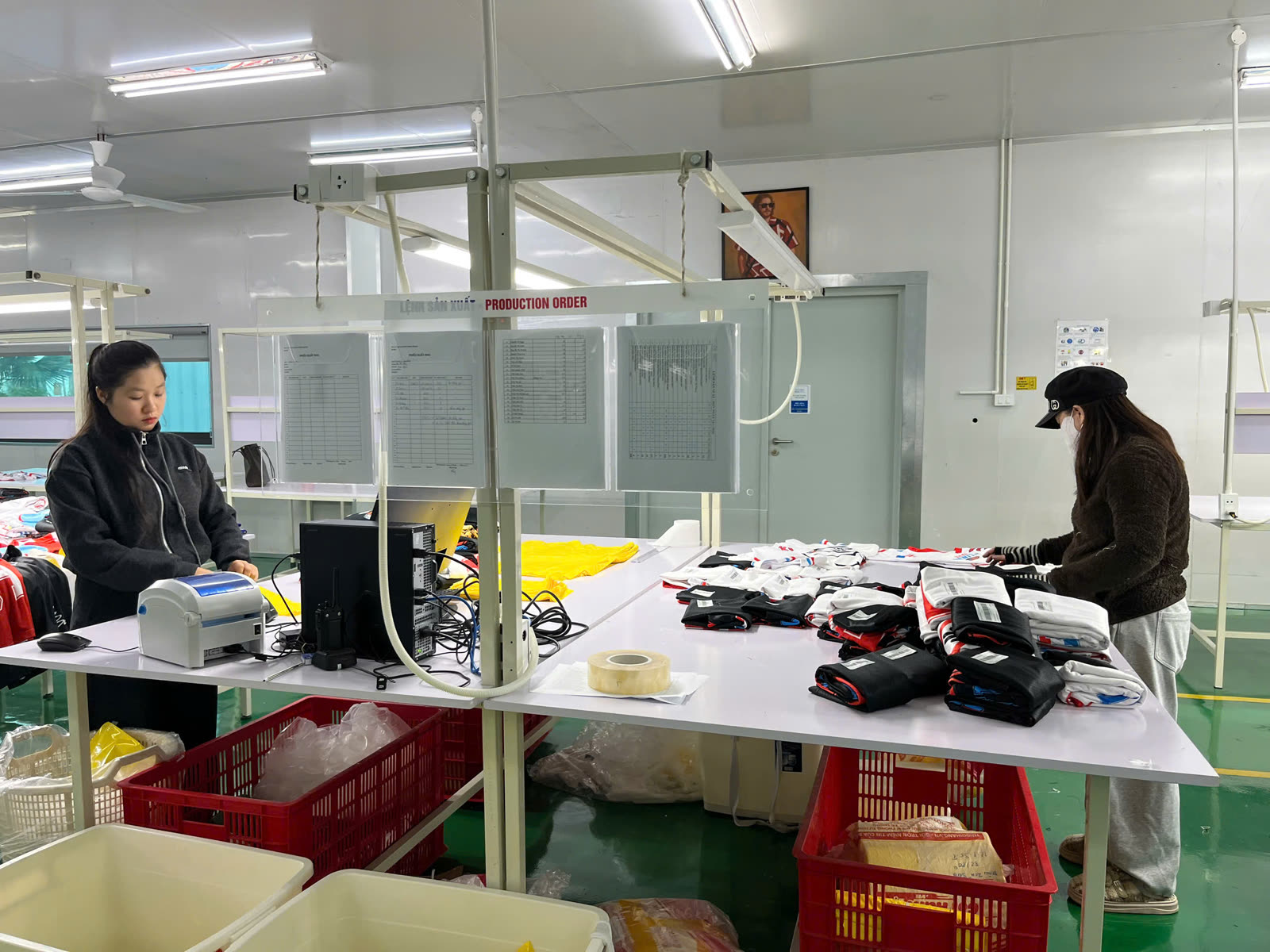 Staff performing quality check and folding printed garments